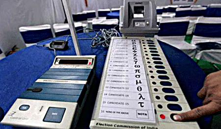 Election officials checking Electronic Voting Machines before polling in India