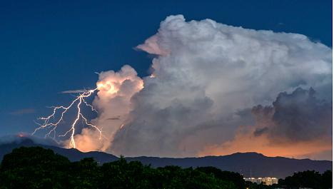 Dark clouds with lightning and heavy rain over Indian landscape during storm alert