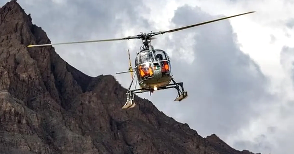 An Indian Army Cheetal helicopter flies over the mountains of Ladakh during ongoing operational missions.